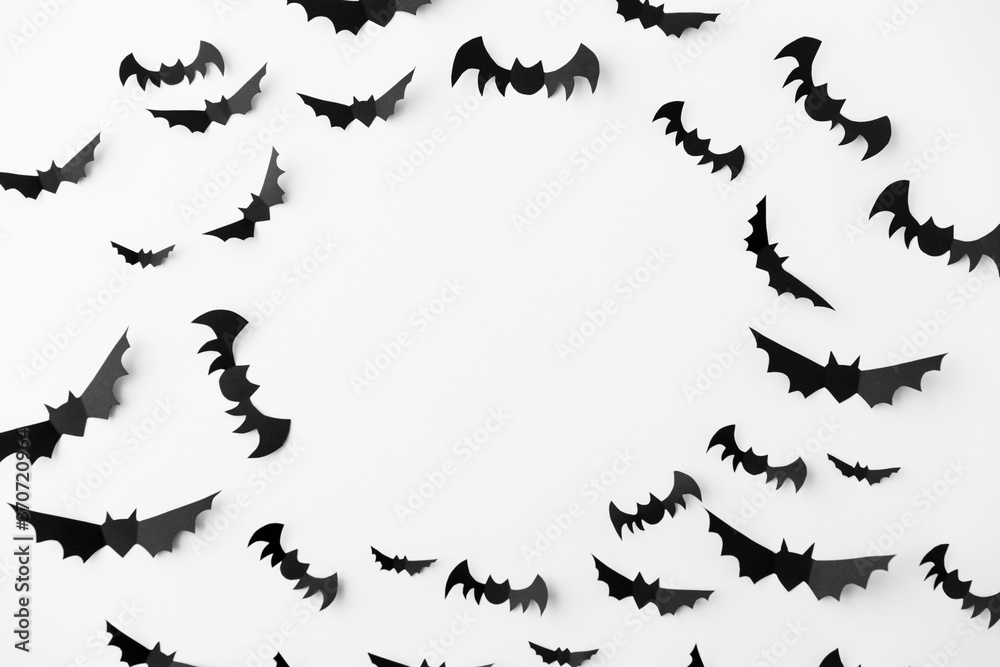 halloween, decoration and scary concept - flock of black paper bats flying over white background halloween, decoration and scary concept - flock of black paper bats flying over white background