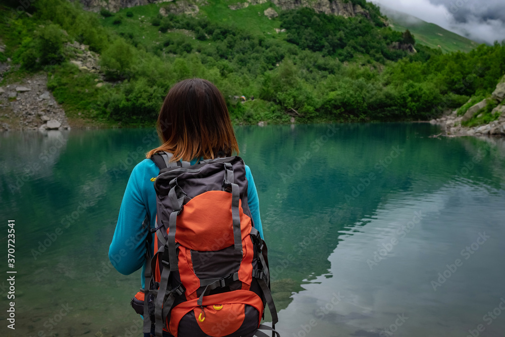 Traveler look at the mountain lake. Travel and active life concept. Traveler look at the mountain lake. Travel and active life concept.