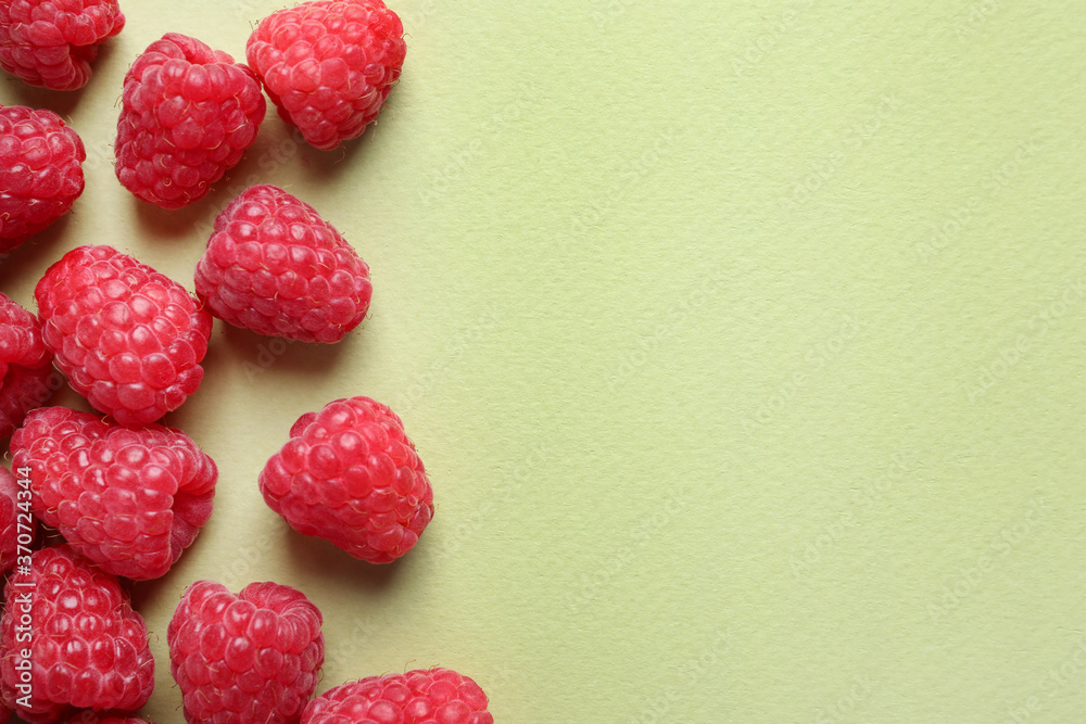 Fresh sweet ripe raspberries on light green background, flat lay. Space for text Fresh sweet ripe raspberries on light green background, flat lay. Space for text