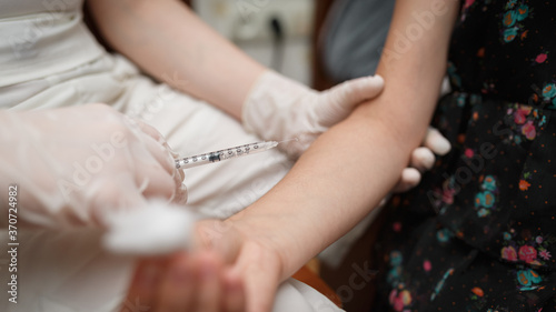 Vaccine injection into the hand of a little girl.