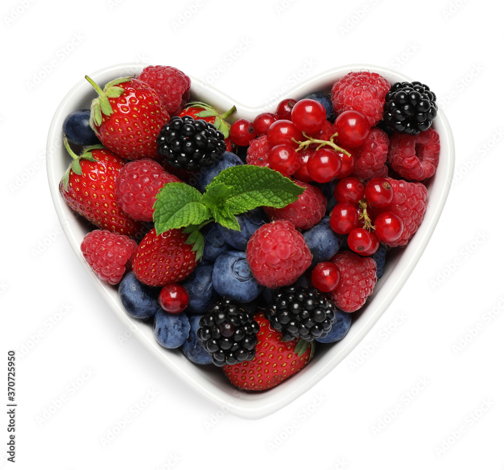 Mix of berries in heart shaped bowl isolated on white, top view Mix of berries in heart shaped bowl isolated on white, top view