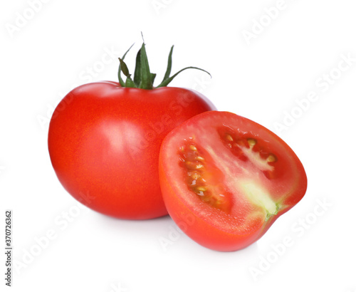 Tasty ripe tomatoes with leaves isolated on white