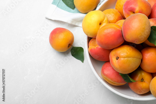 Delicious fresh ripe apricots on white table, flat lay