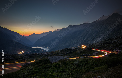 Evening mood on the Grimsel Pass with traces of light from the last motorcycle riders