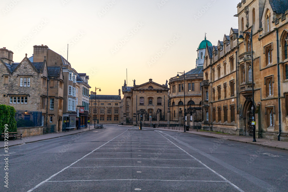 Broad Street in Oxford with no people or vehicles. The Clarendon Building and The Sheldonian Theatre in the background. Early in the morning. Oxford, England, UK.