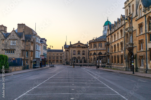 Broad Street in Oxford with no people or vehicles. The Clarendon Building and The Sheldonian Theatre in the background. Early in the morning. Oxford, England, UK. photo