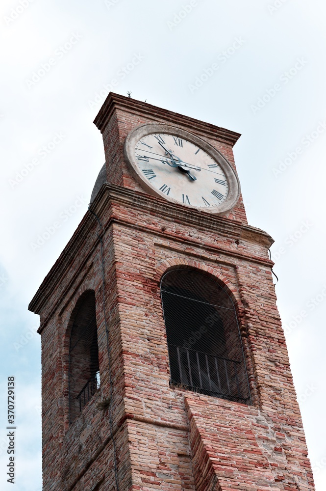 A medieval bell and clock tower of an ancient church (Pesaro, Italy, Europe)