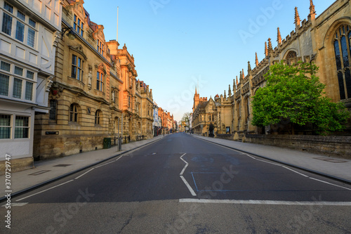 Oxford's High Street at sunrise with no people around, early in the morning on a clear day with blue sky. Oxford, England, UK.
