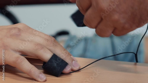 Placing polygraph sensors on a person's fingers. photo