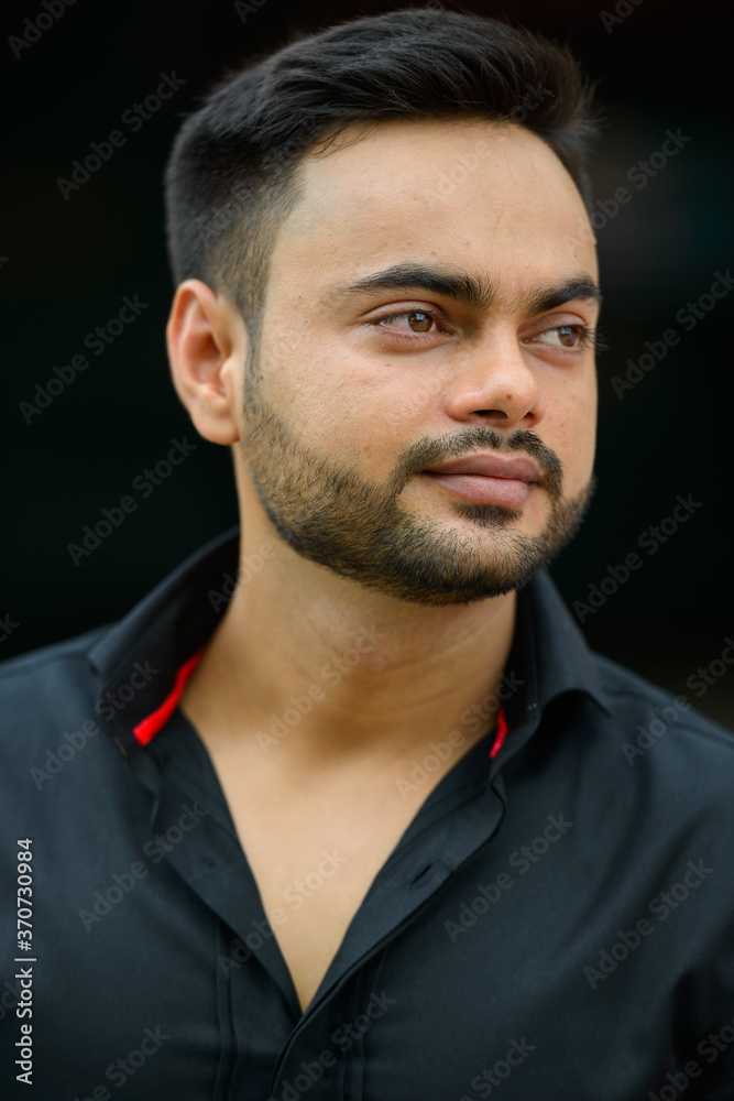 Young handsome bearded Indian businessman in the city Young handsome bearded Indian businessman in the city