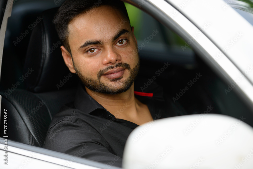 Young handsome bearded Indian businessman in the city Young handsome bearded Indian businessman in the city