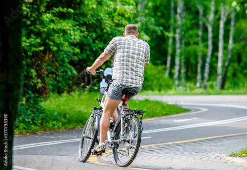 Cyclist ride on the bike path in the city Park 