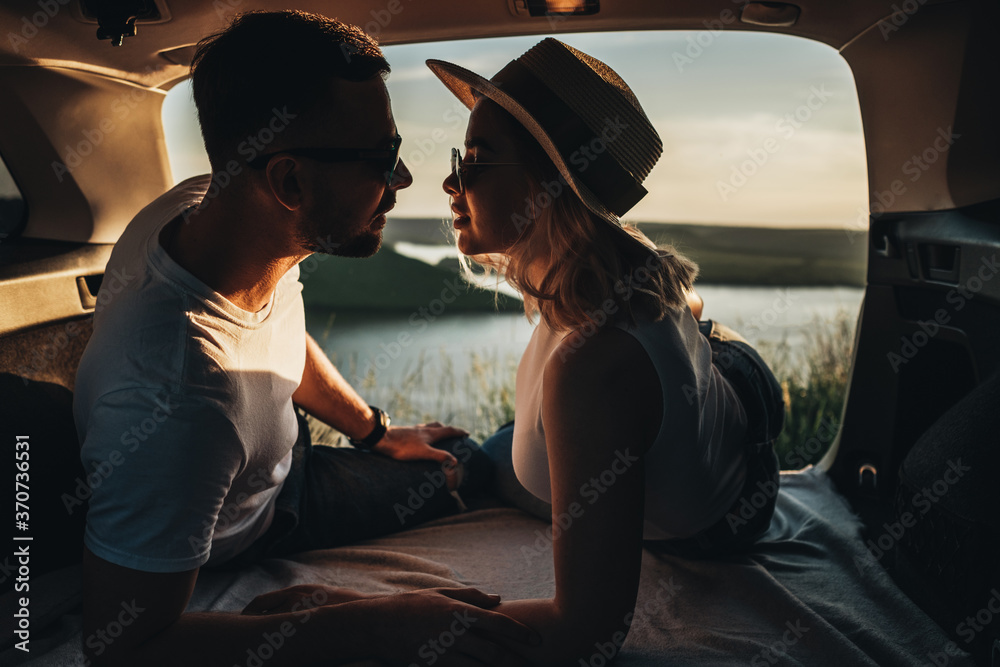 Man and Woman Relaxing Inside the Car Trunk Enjoying Weekend Road Trip, Travel and Adventure Concept