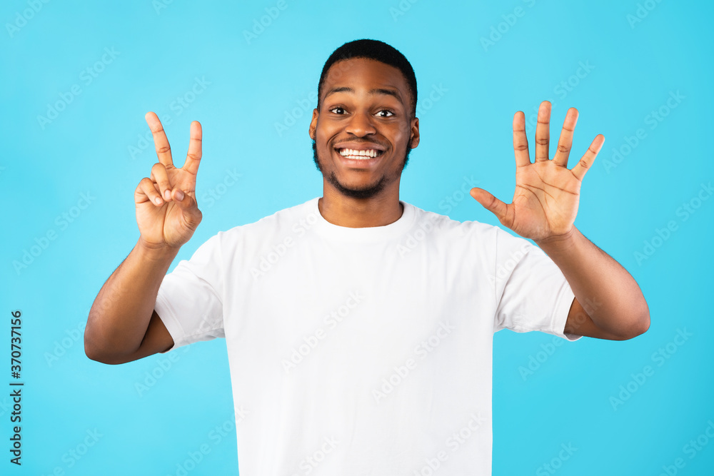 Black Man Showing Number Seven Smiling To Camera, Blue Background Black Man Showing Number Seven Smiling To Camera, Blue Background