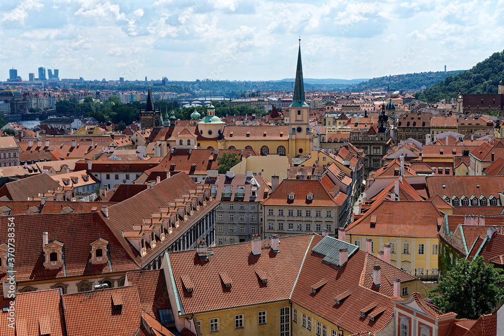 view of St. Thomas church and the red roofs of prague from castle