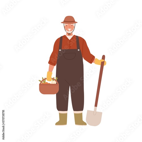 Elderly agrarian, old farmer in work dungarees standing with shovel, vegetable basket. Retired man, seasonal harvest. Farming, gardening. Flat vector cartoon illustration isolated on white background