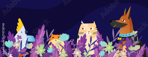 Funny pets sitting in the grass and flowers.