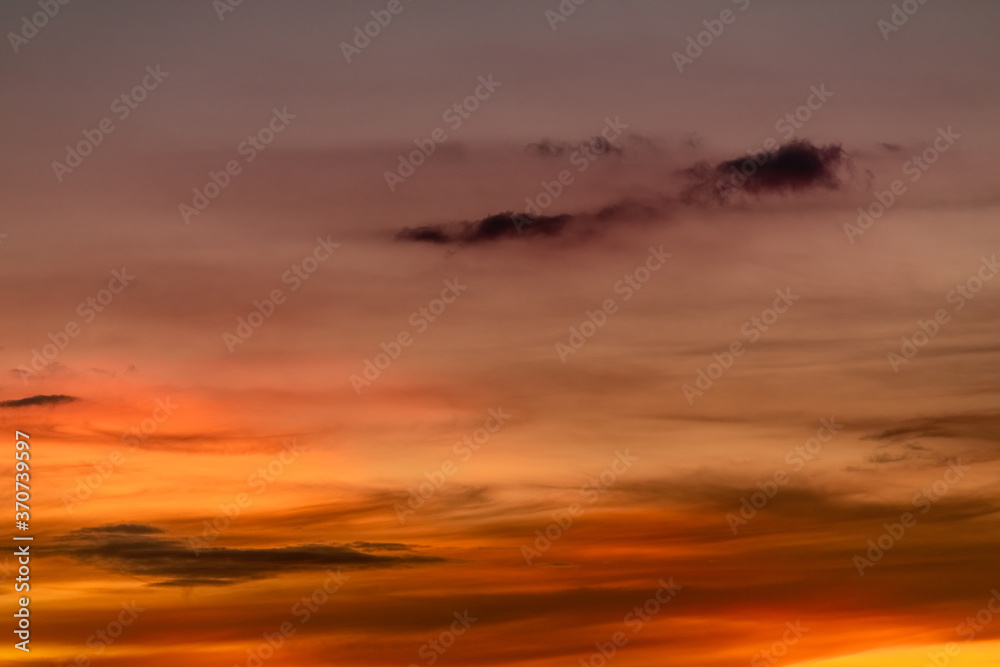 Beautiful sunset sky. Golden sunset sky. Orange, yellow, and red clouds in the evening. Freedom and calm background. Beauty in nature at tropical climate. Peaceful and spiritual scene. Romantic sky.
