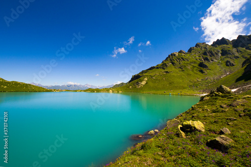 Fototapeta Naklejka Na Ścianę i Meble -  Alpine mountain lake landscape and view, blue beautiful and amazing lake panorama