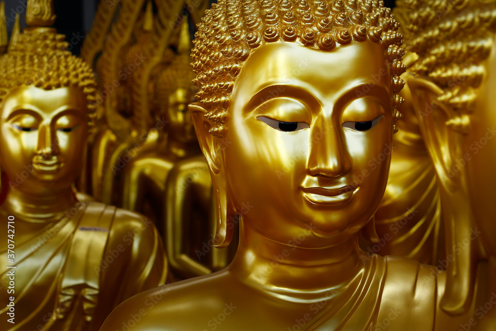 close up of head of statue of buddha, in buddhist temple ,with golden color
