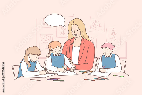 Education, study, learning, lesson, communication concept. Young smiling woman teaching happy children kids boys girls in kindergarten drawing pictures together. Educational process playing at school.