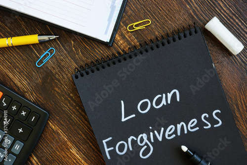 Loan forgiveness note on notepad black page.