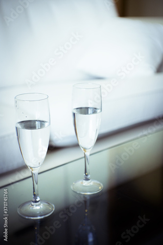 Two glasses of water on a glass table