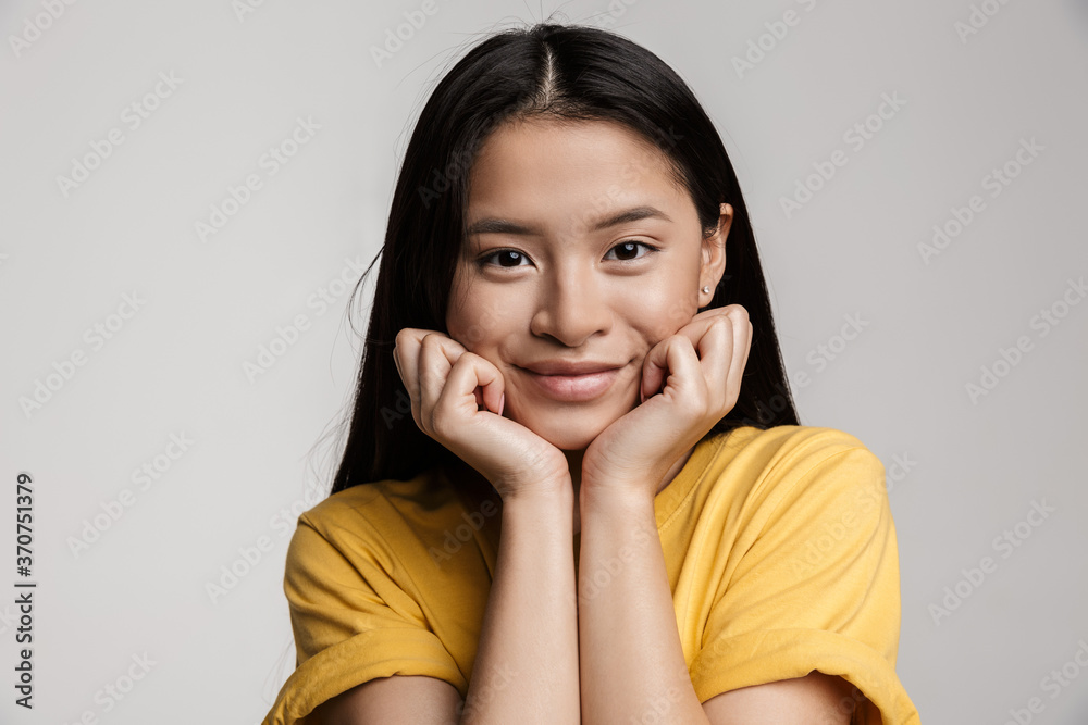 Beautiful young asian woman isolated on gray Beautiful young asian woman isolated on gray