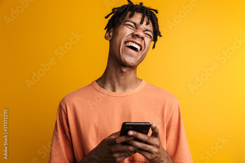 Young happy african man with cellphone isolated