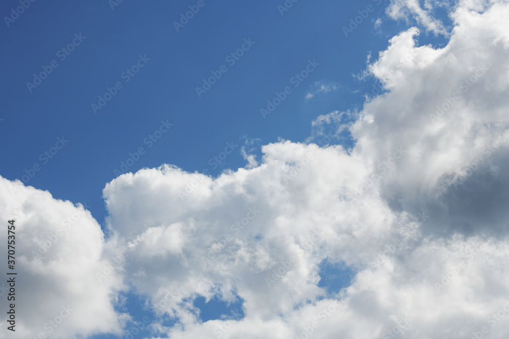 Pre-storm cumulus clouds against blue sky