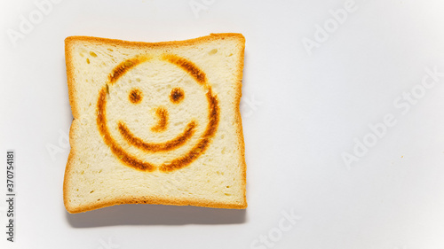 White bread toast with smile on white background
