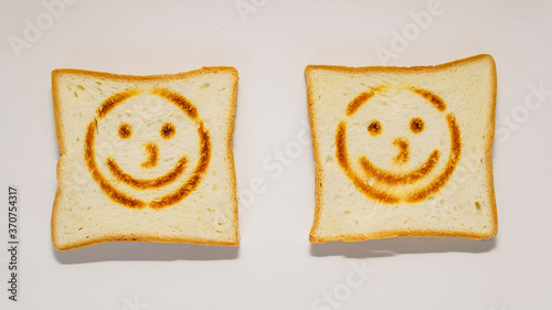 White bread toast with smile on white background