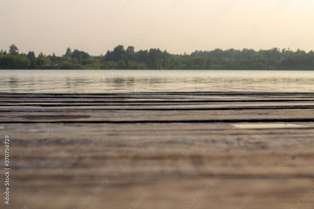 Wooden pier on the water. A quiet place to relax and reflect