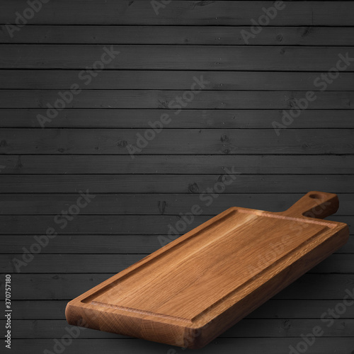 Empty serving board close-up on a wooden background. Place to place your own meal or object. Culinary concept.