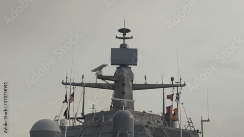 Pan shot of navy ship bridge and naval gun