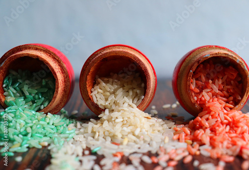 Three colors of rice to resemble the Indian tri colored map. Each color placed in Indian traditional wood bowl called lakka pidatha for the occation of Indian independence day celebrations photo