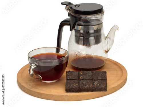 The cup of the chinese black pu-erh tea, teapot on a wooden board photo