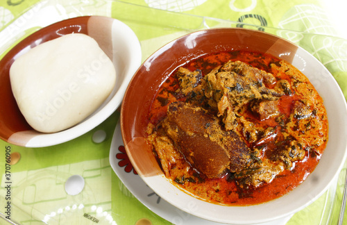 A delicious local African meal of fufu and Egusi soup. This is a Nigerian delicacy usually served at restaurants.  photo