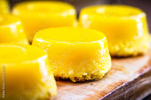Fototapeta Naklejka Na Ścianę i Meble -  Brazilian quindim is a sweet made from egg yolk, sugar and grated coconut. Corresponds to the Portuguese recipe known as brisa-do-Lis, using grated coconut or almond.