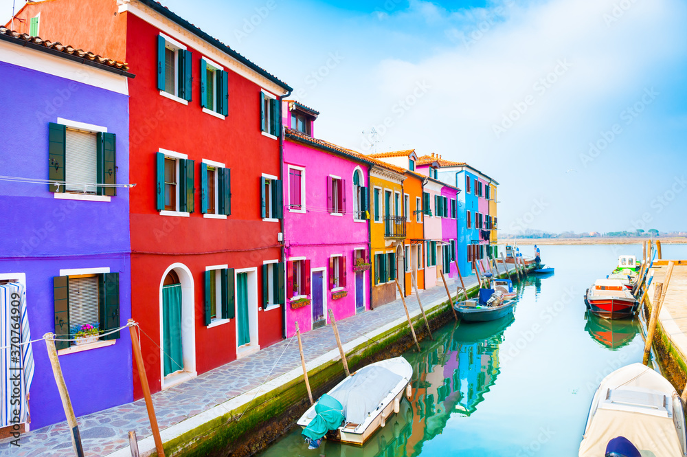 Colorful houses on the canal in Burano island, Venice, Italy. Famous travel destination. Summer landscape