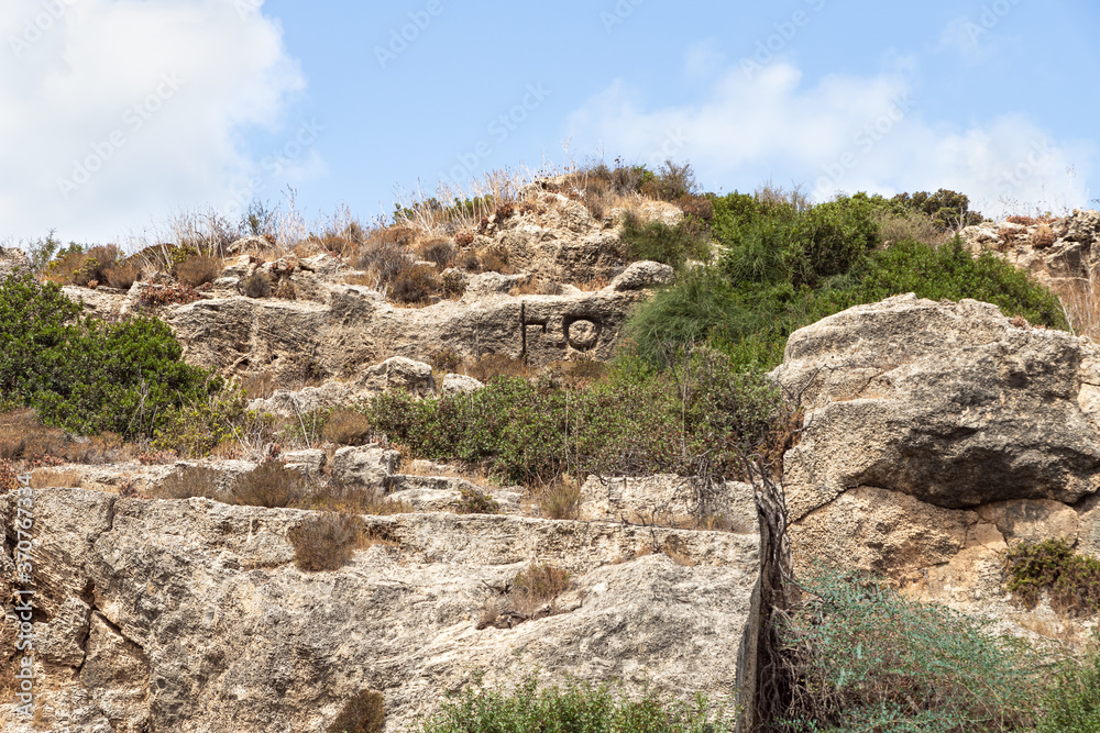 The letters A and T in the old Phoenician language are carved on the stone wall of the old Phoenician fortress, which later became the Roman city of Karta, near the city of Atlit in northern Israel The letters A and T in the old Phoenician language are carved on the stone wall of the old Phoenician fortress, which later became the Roman city of Karta, near the city of Atlit in northern Israel