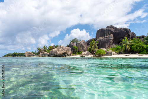 Beautiful island in the seychelles. La digue, anse d'argent beach. Water flowing, and waves foam on a tropical landscape