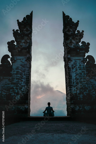 Wallpaper Mural Man meditating and looking at volcano in Bali Torontodigital.ca
