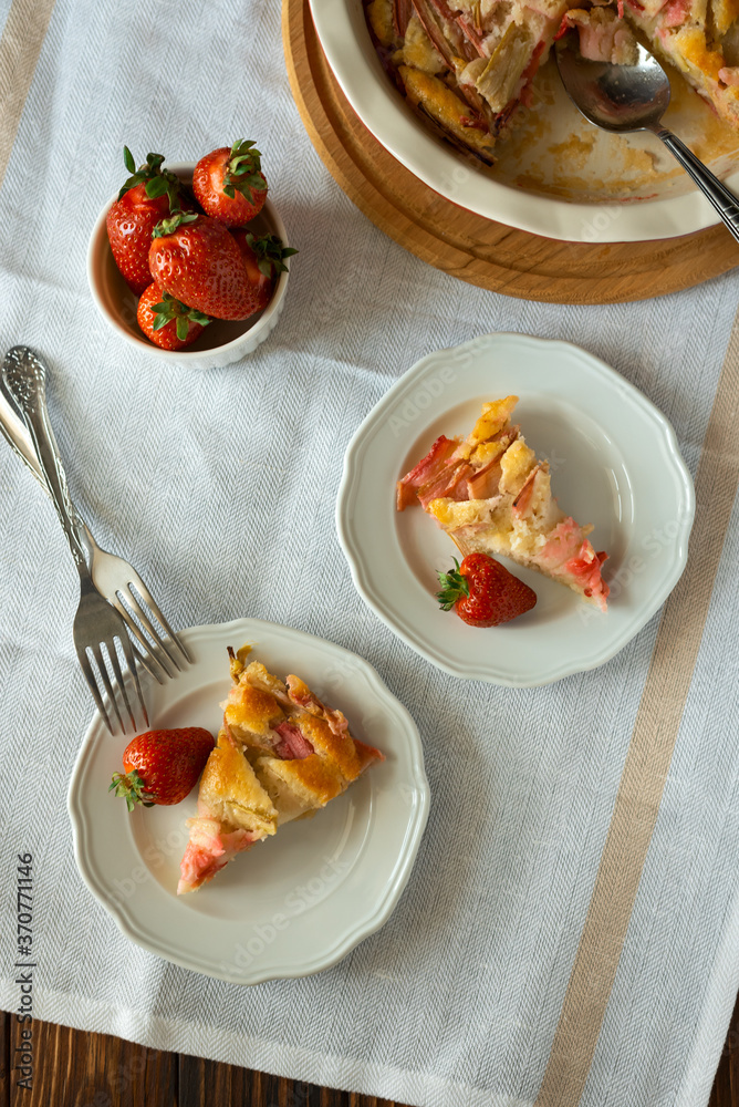 Piece of fresh strawberry and rhubarb pie on plate. Summer food eating. Top view Piece of fresh strawberry and rhubarb pie on plate. Summer food eating. Top view