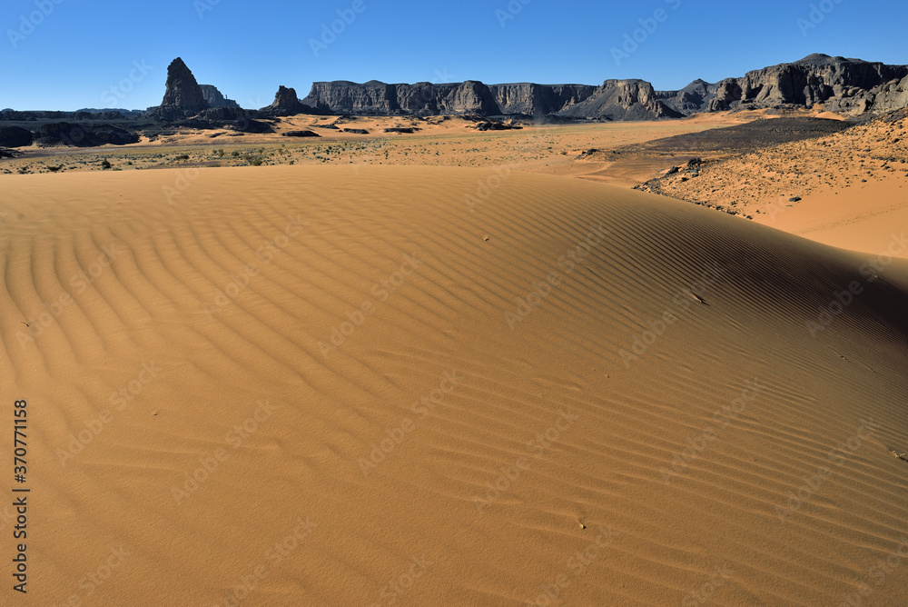 TADRART NATIONAL PARK IN THE SAHARA DESERT IN ALGERIA. SAND DUNES AND ROCK FORMATIONS. SAFARI AND ADVENTURE IN ALGERIA. TOURISM IN ALGERIA TADRART NATIONAL PARK IN THE SAHARA DESERT IN ALGERIA. SAND DUNES AND ROCK FORMATIONS. SAFARI AND ADVENTURE IN ALGERIA. TOURISM IN ALGERIA