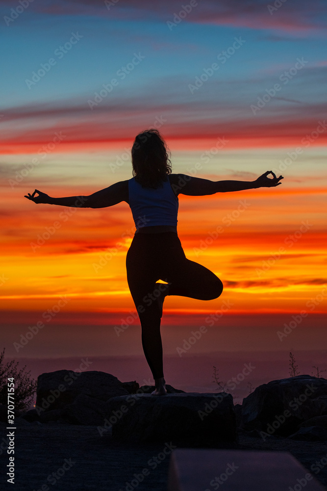 Silhouette of a woman doing yoga