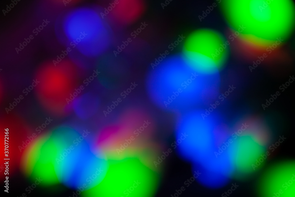 Red, green, pink, blue, blurry christmas and holiday lights in the dark. Multicolored, bright blurred bokeh background Red, green, pink, blue, blurry christmas and holiday lights in the dark. Multicolored, bright blurred bokeh background