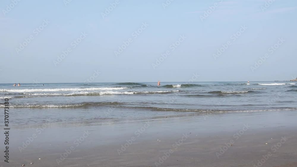 Sandy beach and sea waves.