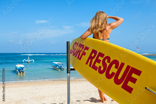 Fotografie Life saving yellow board with surf rescue sign
