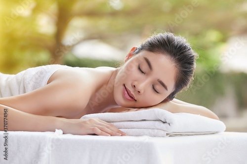 Asian woman relaxing while receiving oriental massage 
